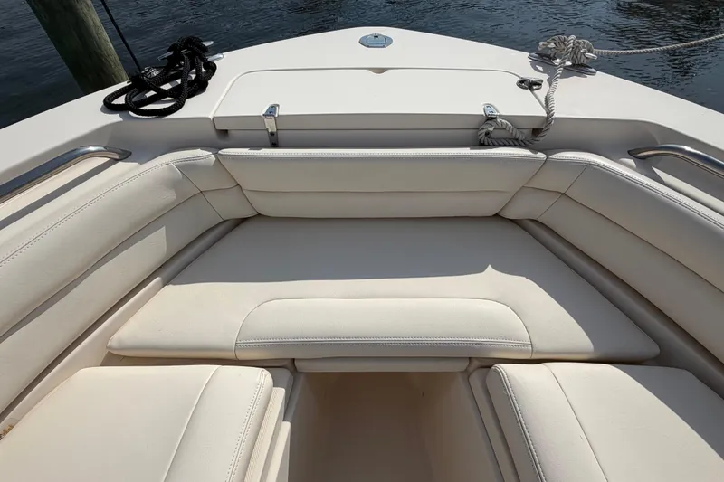 Slide: The Image of Bow seating area of 2018 Grady-White Fisherman 236 boat, featuring cushioned seats. - 14