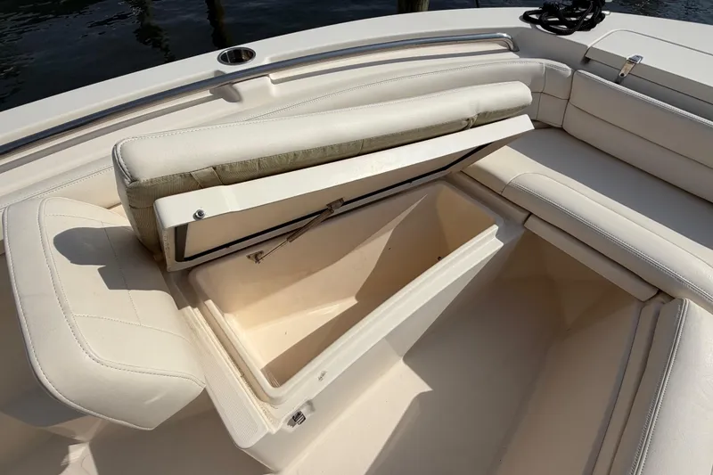 Slide: The Image of Open storage compartment on 2018 Grady-White Fisherman 236 boat with cushioned seating. - 15