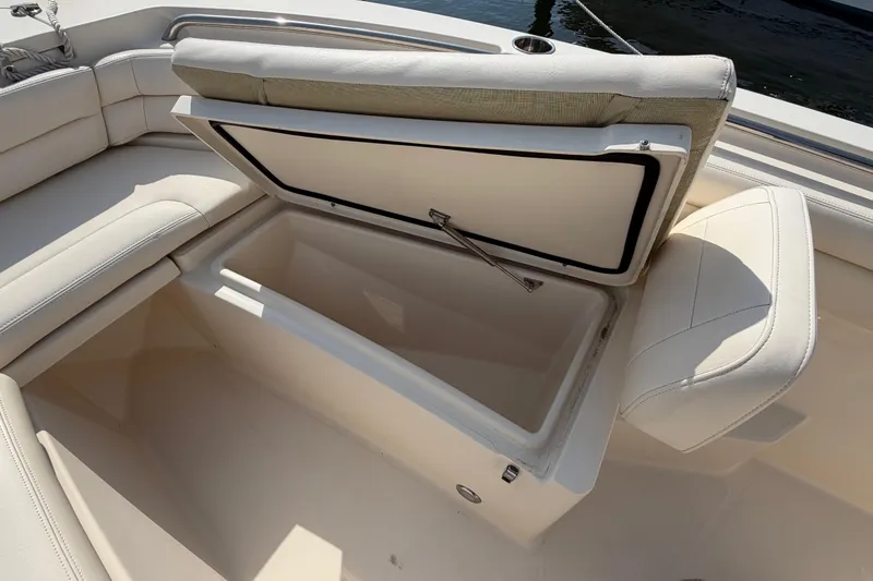 Slide: The Image of Open storage compartment on 2018 Grady-White Fisherman 236 boat with cushioned seating. - 16