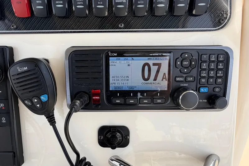 Slide: The Image of ICOM marine radio and controls on a 2018 Grady-White Fisherman 236 boat dashboard. - 25