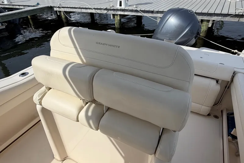 Slide: The Image of 2018 Grady-White Fisherman 236 boat interior with cushioned seating and docked engine. - 29