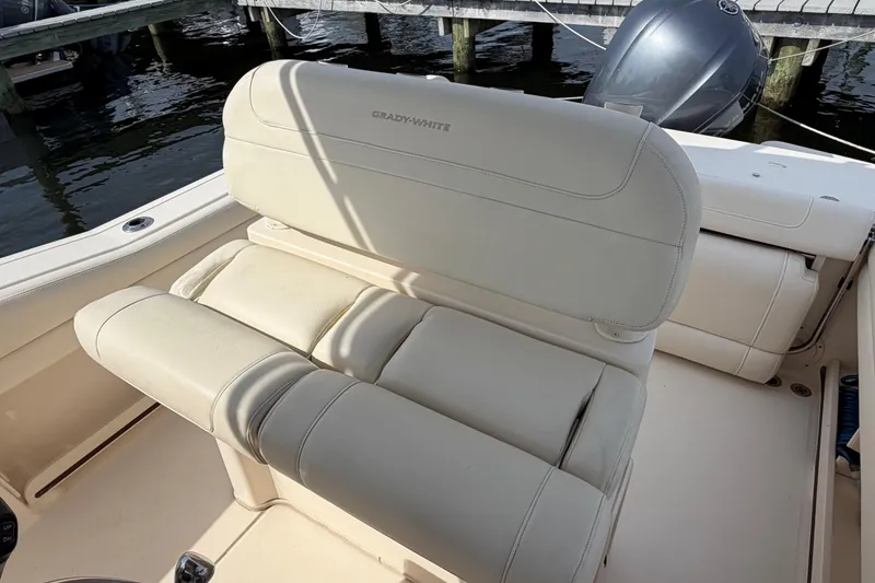 Slide: The Image of 2018 Grady-White Fisherman 236 boat seat, beige upholstery, docked by water. - 30