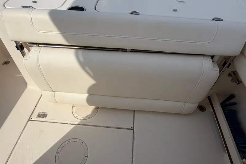 Slide: The Image of 2018 Grady-White Fisherman 236 boat interior with white cushioned seating. - 33