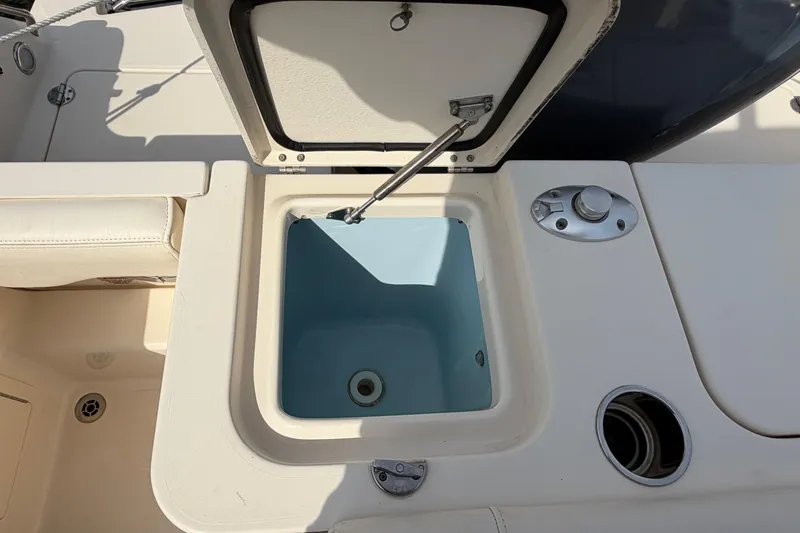 Slide: The Image of Open storage compartment on a 2018 Grady-White Fisherman 236 boat deck. - 34