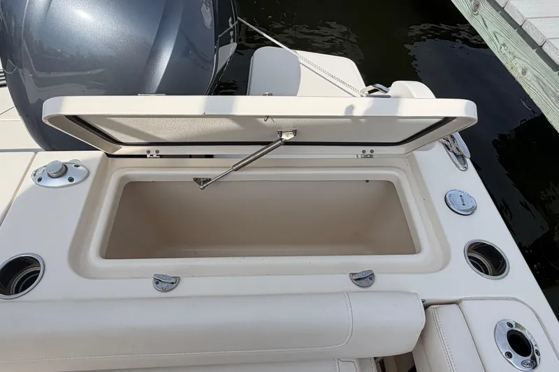 Slide: The Image of Open storage compartment on 2018 Grady-White Fisherman 236 boat, docked by water. - 35