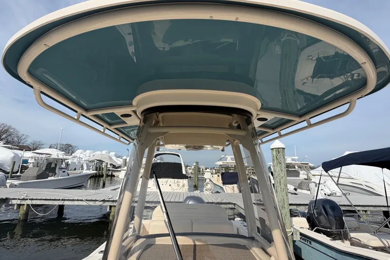Slide: The Image of 2018 Grady-White Fisherman 236 boat at marina, featuring a sleek hardtop design. - 36