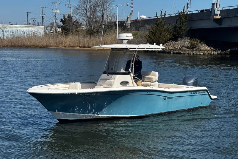 Slide: The Image of 2018 Grady-White Fisherman 236 boat on calm water near a bridge. - 5