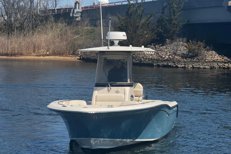 Slide: The Image of 2018 Grady-White Fisherman 236 boat on calm water near a bridge. - 8