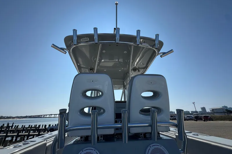 Slide: The Image of 2016 Contender 35 ST boat with dual seats and T-top under clear sky. - 16