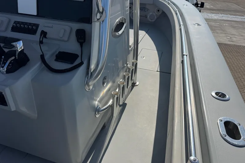 Slide: The Image of 2016 Contender 35 ST boat cockpit with control panel and rod holders. - 18