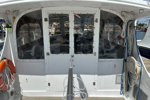 Slide: The Image of 1996 KenCraft Down East Express 35 boat stern with doors and docked equipment. - 11