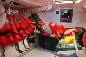 Slide: The Image of Storage area in a 1996 KenCraft Down East Express 35 with life jackets and safety gear. - 14