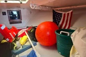 Slide: The Image of Storage area in a 1996 KenCraft Down East Express 35 with safety gear and American flag. - 15