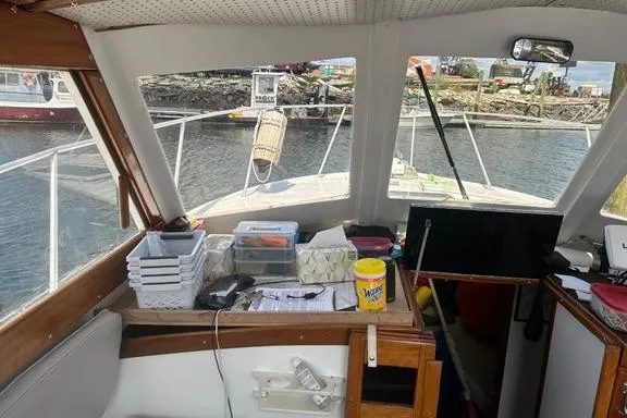 Slide: The Image of Interior view of a 1996 KenCraft Down East Express 35 boat with organized supplies. - 2