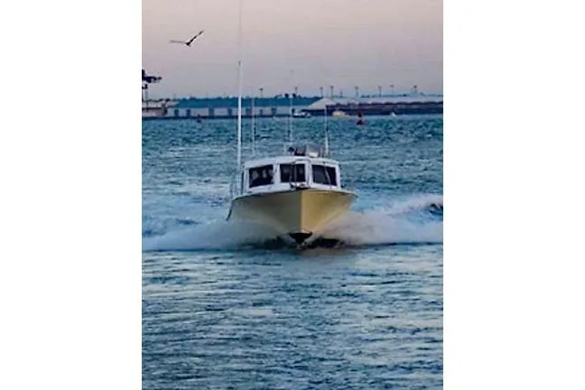 Slide: The Image of 1996 KenCraft Down East Express 35 cruising on open water at sunset. - 23