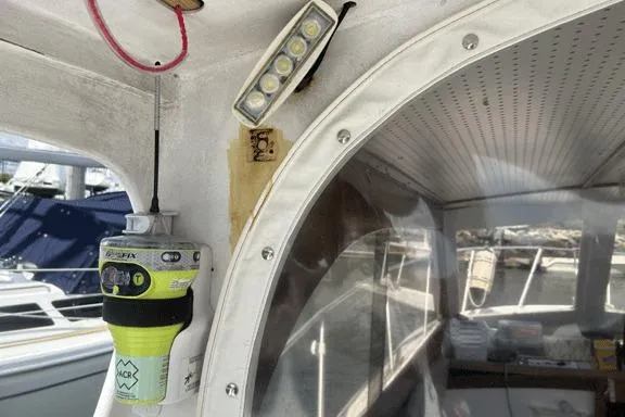 Slide: The Image of Interior view of a 1996 KenCraft Down East Express 35 boat, featuring a mounted radio and LED light. - 28