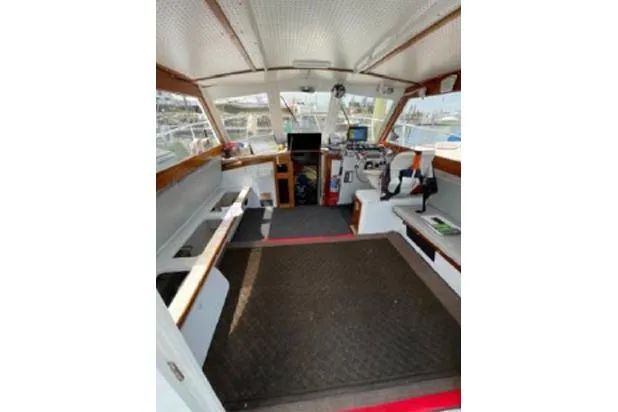 Slide: The Image of 1996 KenCraft Down East Express 35 boat interior with helm, seating, and navigation equipment. - 3