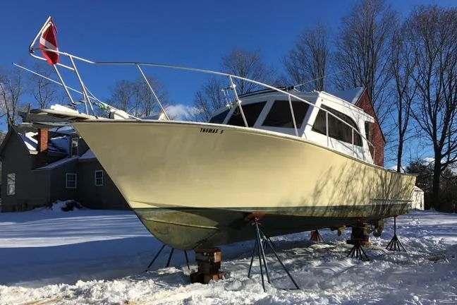 Slide: The Image of 1996 KenCraft Down East Express 35 boat on stands in snowy yard. - 31