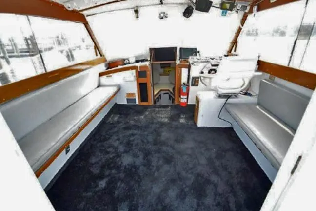 Slide: The Image of Interior of 1996 KenCraft Down East Express 35 boat with seating and navigation equipment. - 4