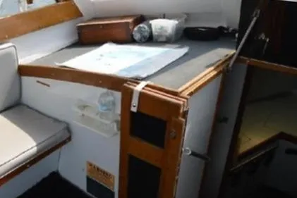 Slide: The Image of 1996 KenCraft Down East Express 35 cabin interior with seating and navigation area. - 7