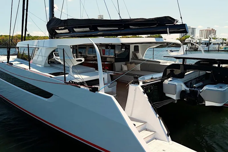 Slide: The Image of 2026 HH Catamarans HH60 luxury yacht docked, showcasing sleek design and spacious deck. - 10