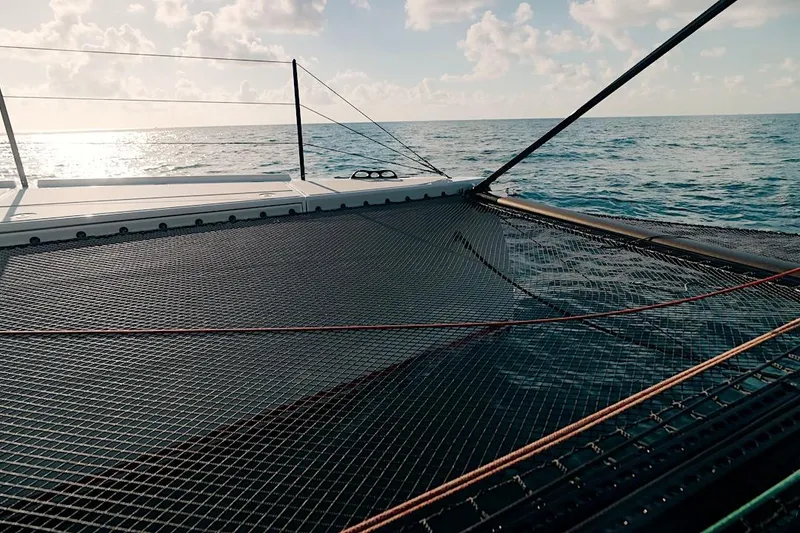 Slide: The Image of Trampoline deck of 2026 HH Catamarans HH60 sailing on open sea. - 12