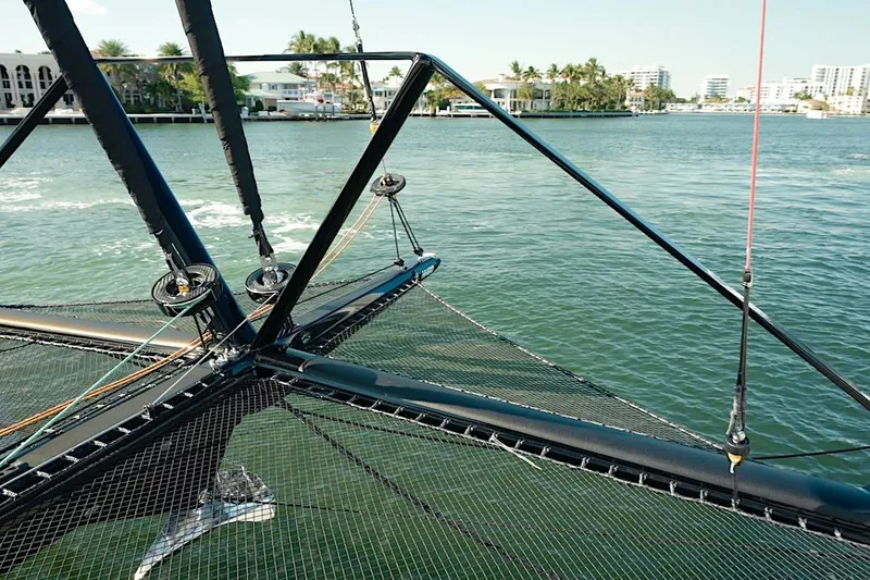 Slide: The Image of 2026 HH Catamarans HH60 sailing on calm waters, showcasing advanced rigging and sleek design. - 13