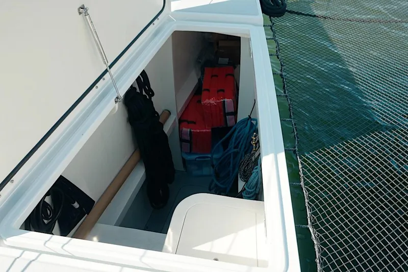 Slide: The Image of Storage compartment on 2026 HH Catamarans HH60 catamaran, featuring ropes and equipment. - 15