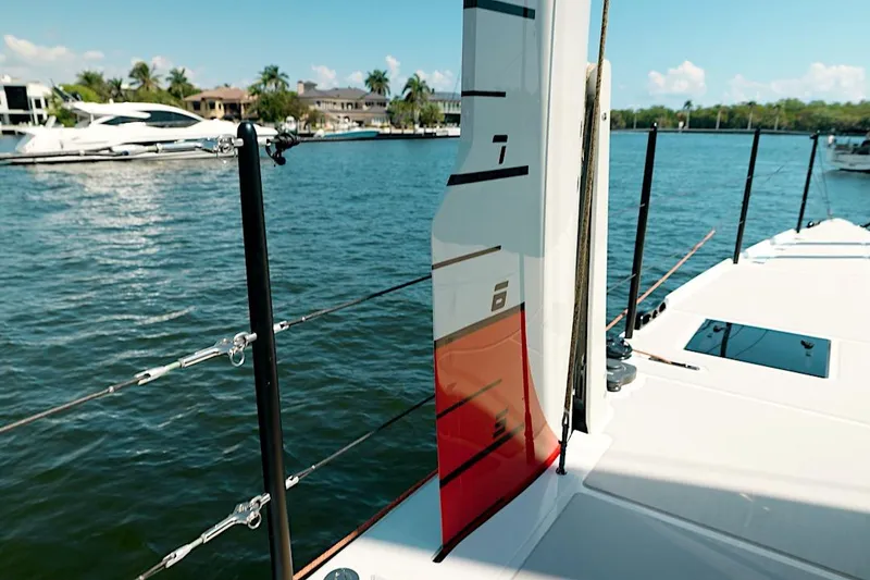 Slide: The Image of Modern HH60 catamaran deck view, 2026 model, docked in a serene marina setting. - 16