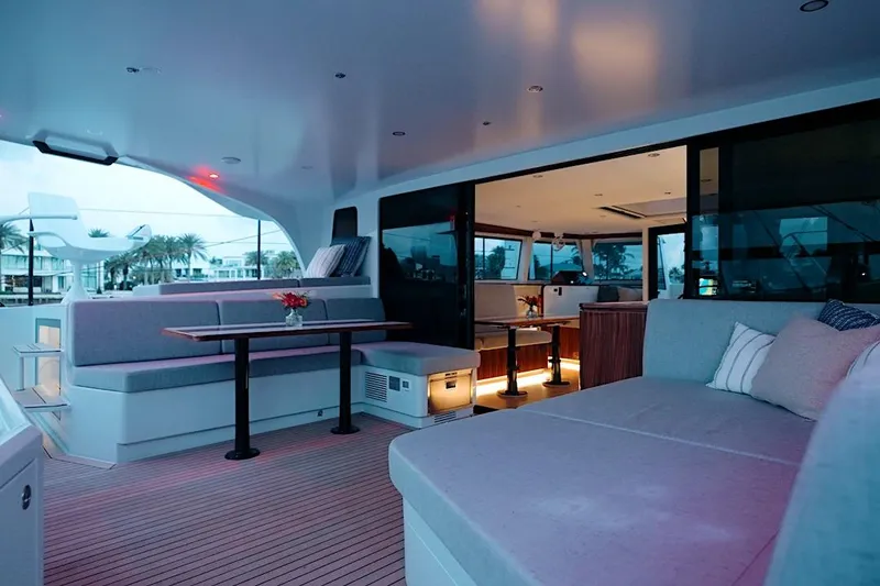 Slide: The Image of Luxurious interior of 2026 HH Catamarans HH60, featuring elegant seating and ambient lighting. - 20
