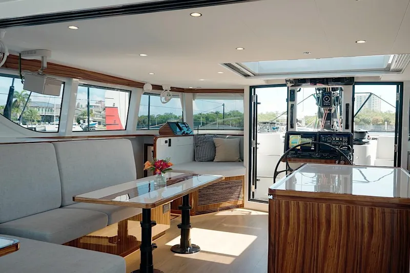 Slide: The Image of Luxurious interior of 2026 HH Catamarans HH60, featuring modern seating and navigation area. - 23