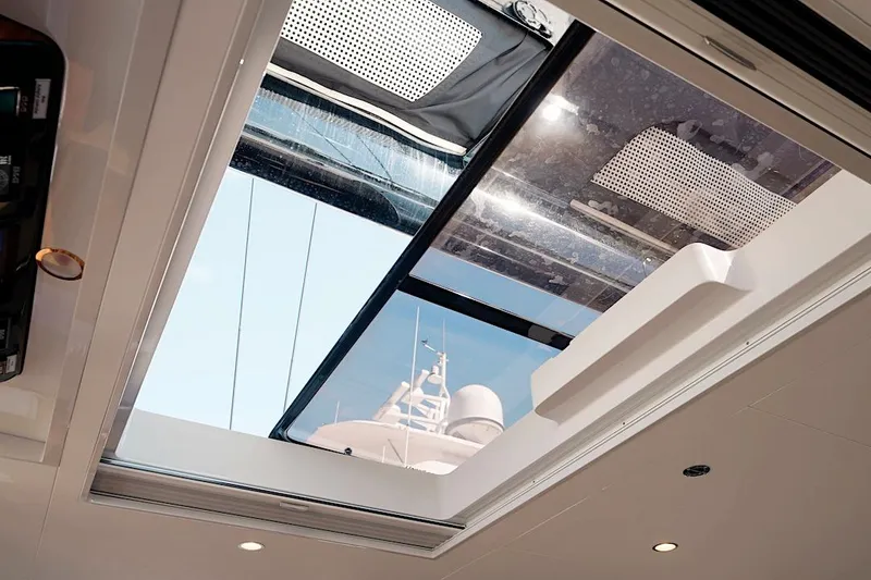 Slide: The Image of Skylight view from 2026 HH Catamarans HH60, showcasing modern design and clear blue sky. - 25