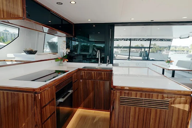 Slide: The Image of Luxurious kitchen interior of 2026 HH Catamarans HH60 yacht with modern wood finish. - 34