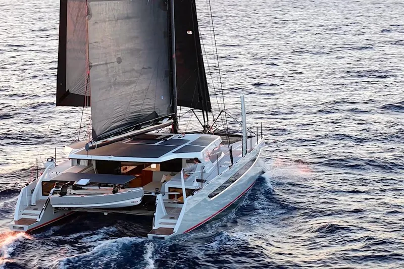 Slide: The Image of 2026 HH Catamarans HH60 sailing on open ocean waters. - 4