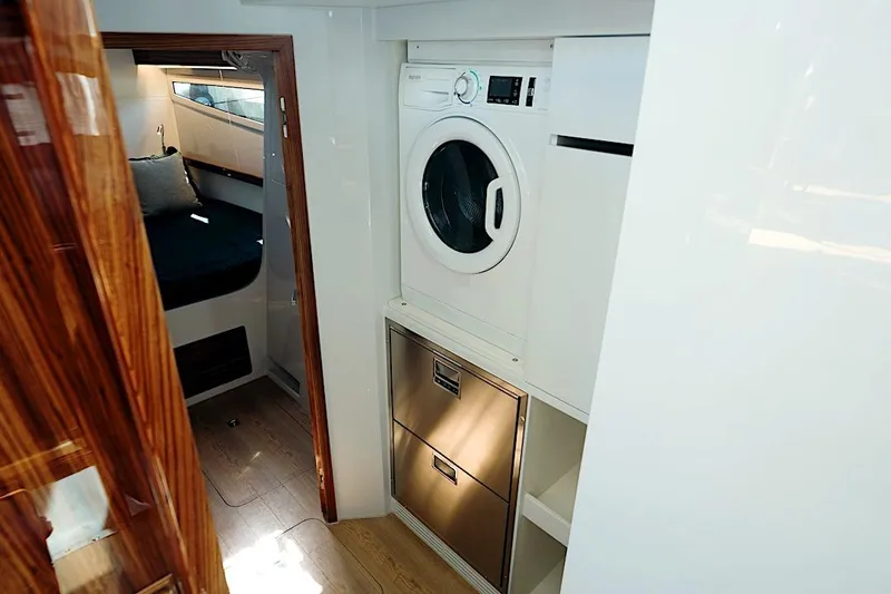 Slide: The Image of Laundry area and cabin interior of 2026 HH Catamarans HH60 yacht. - 43