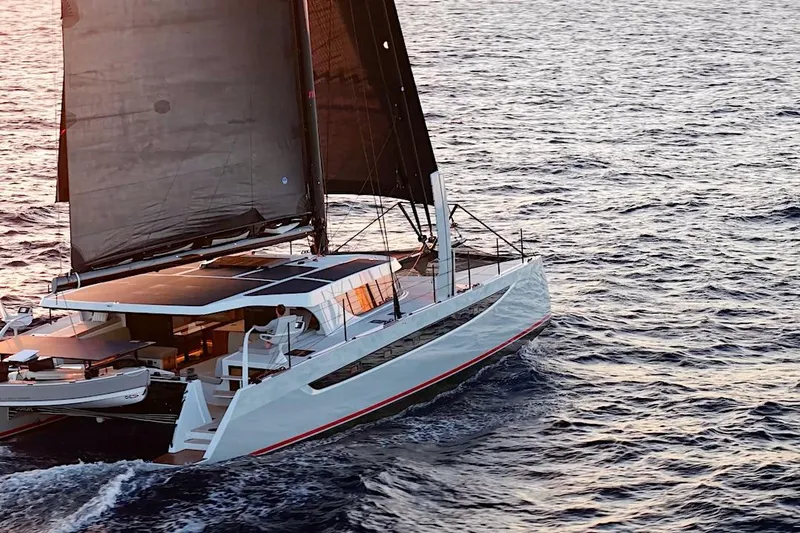 Slide: The Image of 2026 HH Catamarans HH60 sailing on open ocean at sunset. - 5