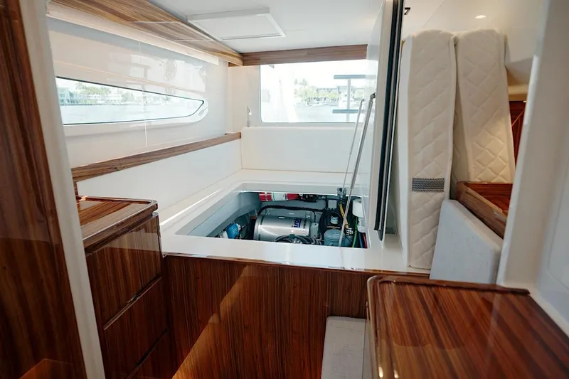 Slide: The Image of 2026 HH Catamarans HH60 interior engine compartment with sleek wood finish. - 50