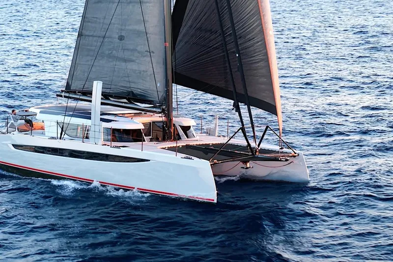 Slide: The Image of 2026 HH Catamarans HH60 sailing on open ocean waters. - 7