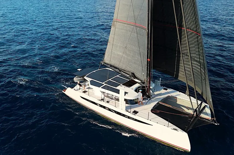 Slide: The Image of Aerial view of 2026 HH Catamarans HH60 sailing on open ocean waters. - 8