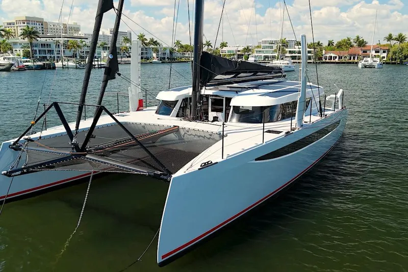 Slide: The Image of 2026 HH Catamarans HH60 sailing in a marina, showcasing sleek design and modern features. - 9