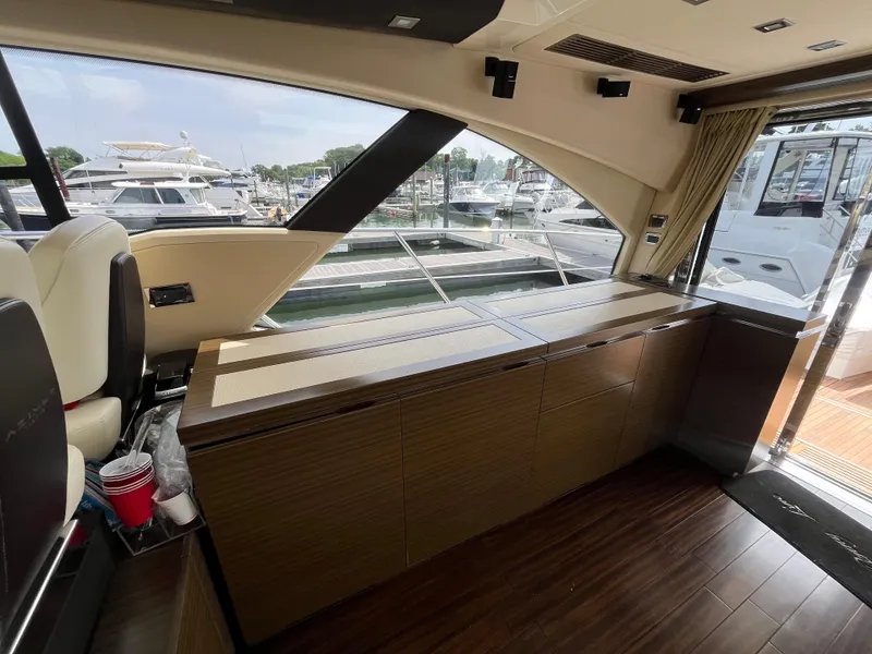 Slide: The Image of Interior of 2014 Azimut 55S yacht with wooden cabinetry and marina view. - 13