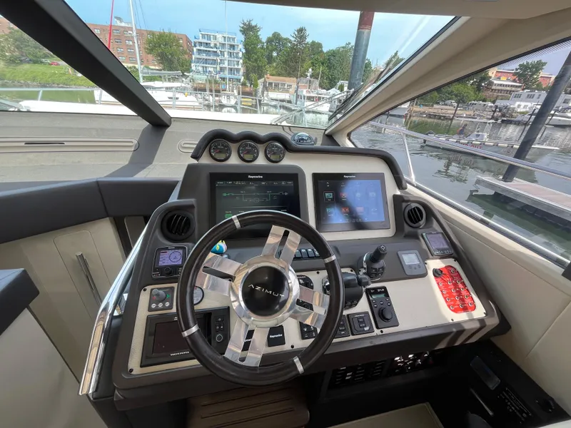 Slide: The Image of Cockpit of 2014 Azimut 55S yacht with advanced navigation controls and steering wheel. - 21