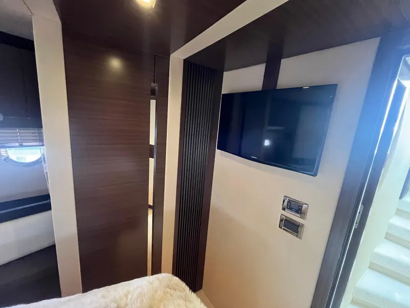 Slide: The Image of Luxurious interior of 2014 Azimut 55S yacht with modern TV and elegant wood paneling. - 27