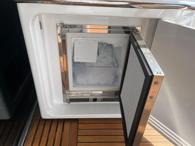 Slide: The Image of Ice maker on 2014 Azimut 55S yacht with open door, showing ice cubes inside. - 42