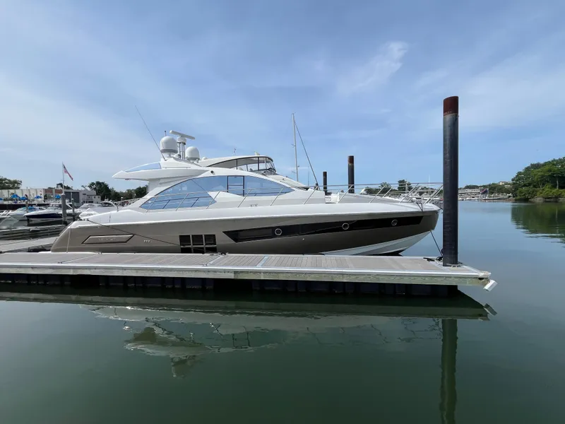Slide: The Image of 2014 Azimut 55S yacht docked at marina, calm water, clear sky. - 44