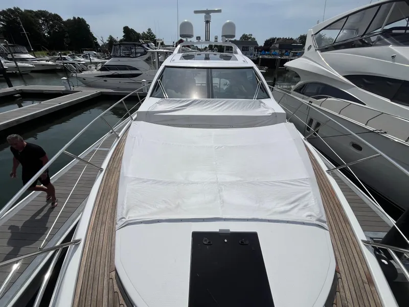 Slide: The Image of 2014 Azimut 55S yacht docked at marina, showcasing sleek design and spacious deck. - 6