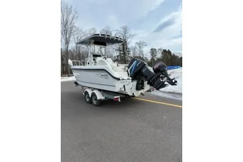 Slide: The Image of 1999 Boston Whaler 21 Outrage boat on trailer, parked on a road with snowy background. - 3