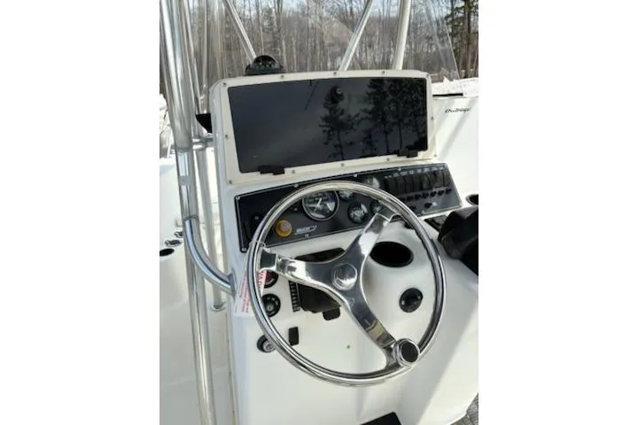 Slide: The Image of Steering console of a 1999 Boston Whaler 21 Outrage boat with gauges and controls. - 6