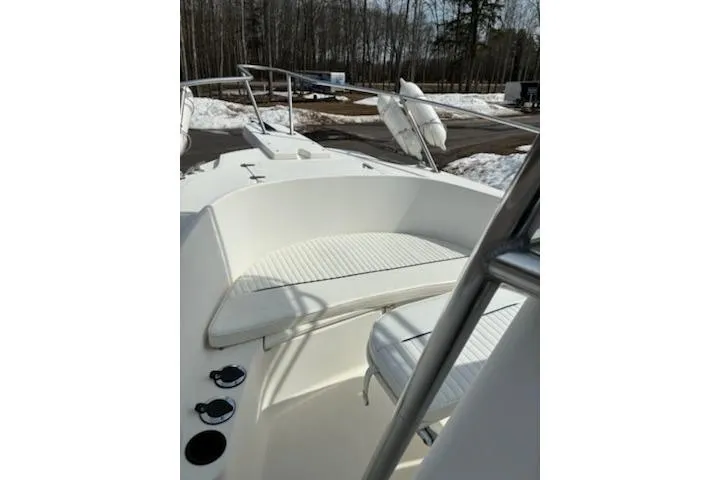 Slide: The Image of 1999 Boston Whaler 21 Outrage boat interior with seating, docked in snowy surroundings. - 7