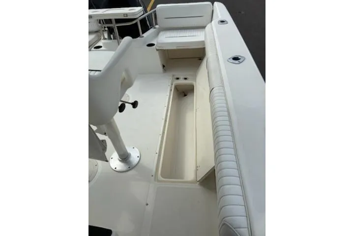 Slide: The Image of 1999 Boston Whaler 21 Outrage boat interior with seating and storage compartments. - 9